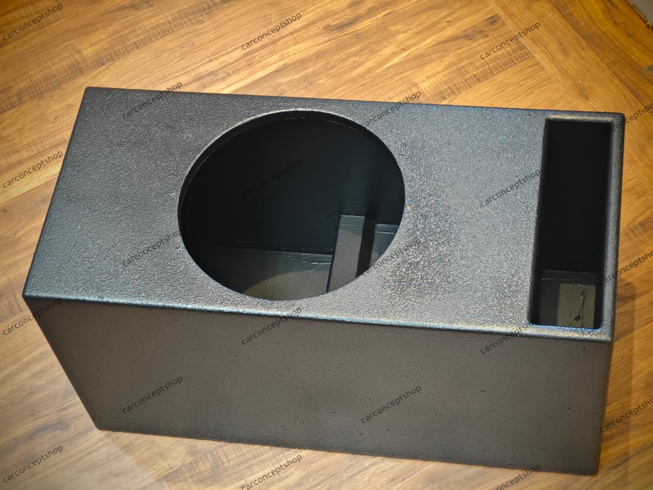 Front perspective of a 12-inch heavy-duty subwoofer enclosure featuring a 3-inch L-port and rugged black textured finish.
